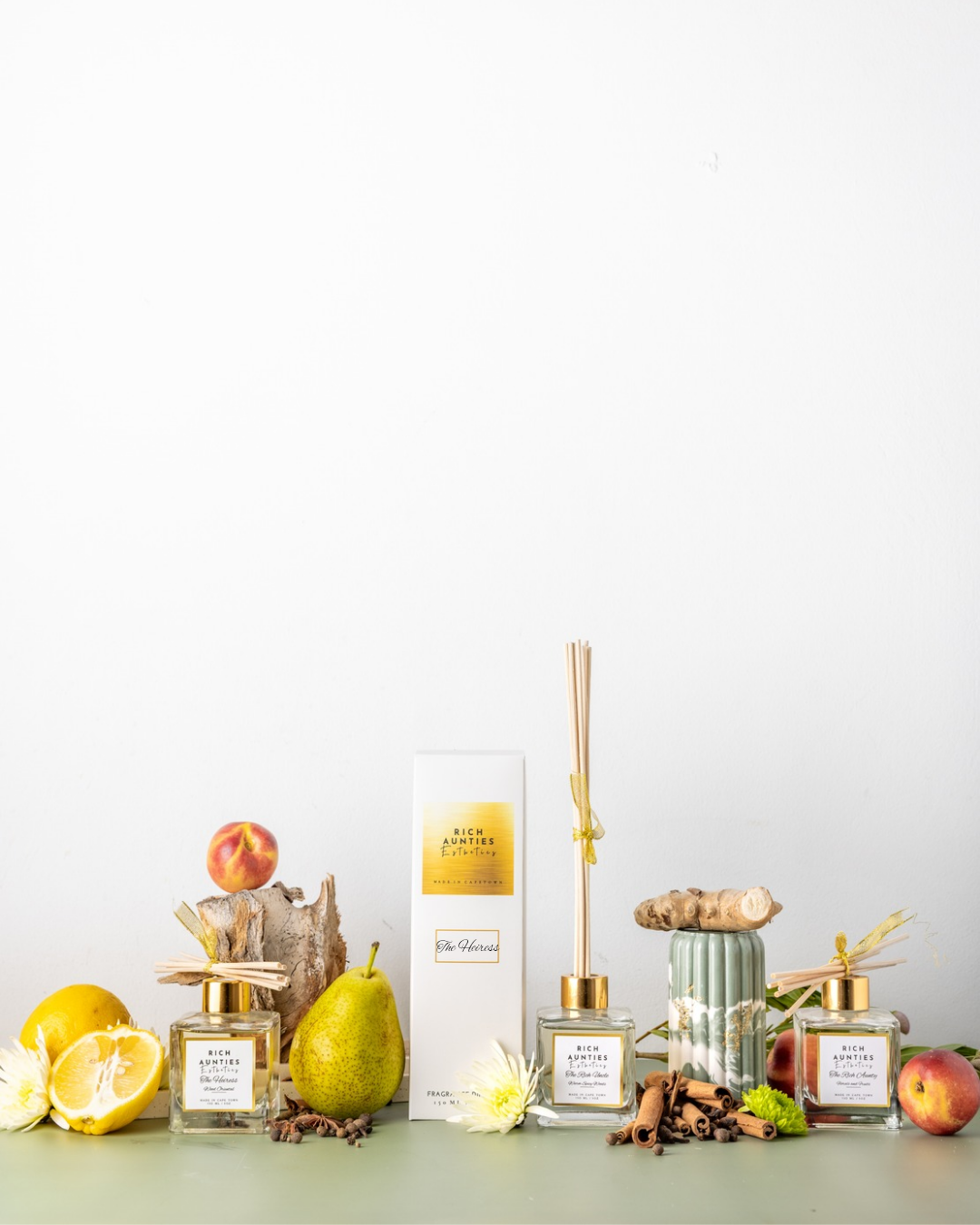 Rich Aunties Esthetics luxury 150ml Heiress wood oriental reed diffuser featuring Laotian oud and rose notes in a square glass bottle. A collection of Rich Aunties Esthetics Diffuser s