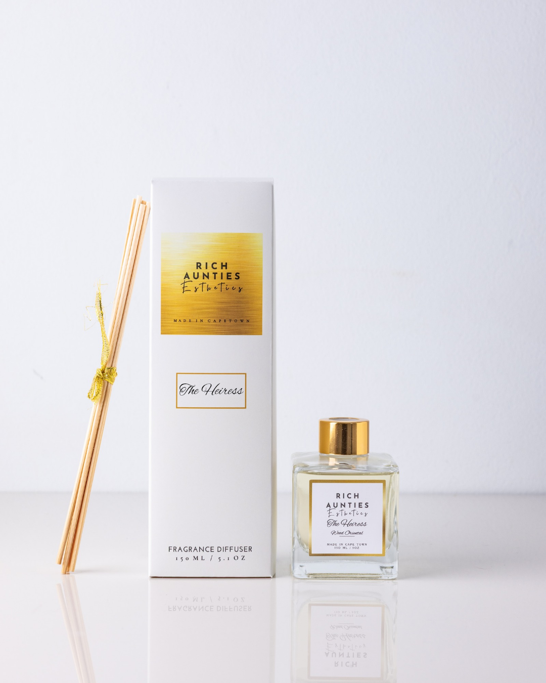 Rich Aunties Esthetics luxury 150ml Heiress wood oriental reed diffuser featuring Laotian oud and rose notes in a square glass bottle and white box