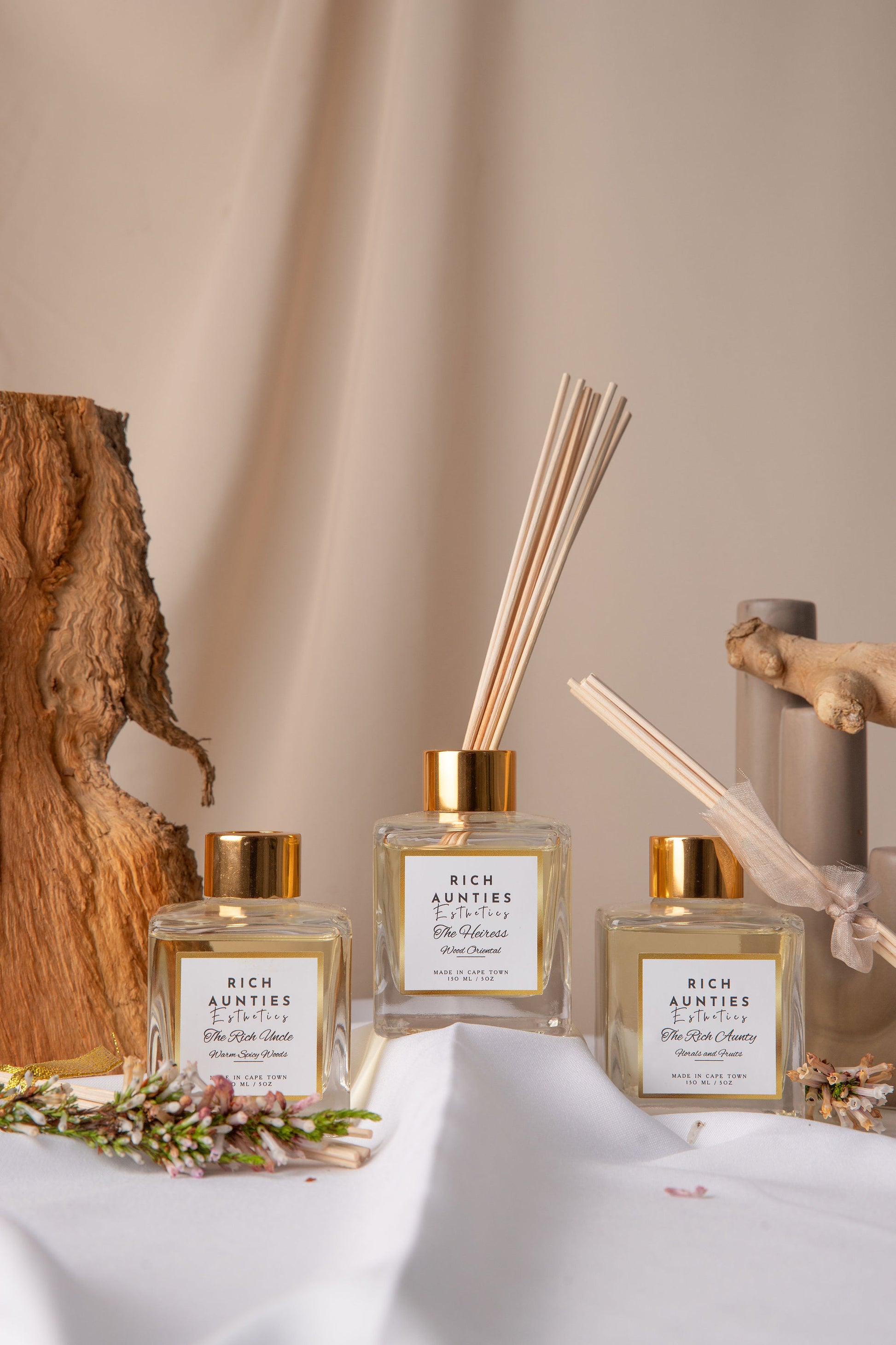 Luxury Reed Diffuser bottles with gold caps and decorative elements on a neutral background